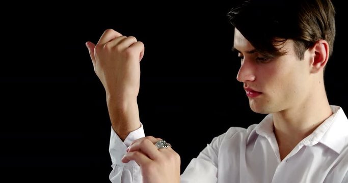 Androgynous man adjusting his hand cuffs