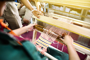 weave yarn on the manual wood loom  handicraft (Saori) ,thailand,selective focus