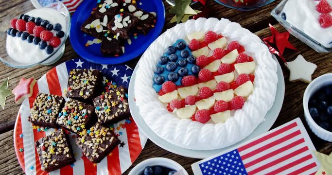 Fruitcake and various sweet foods arranged on wooden table