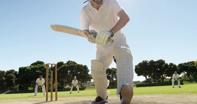 Batsman playing straight drive during cricket match