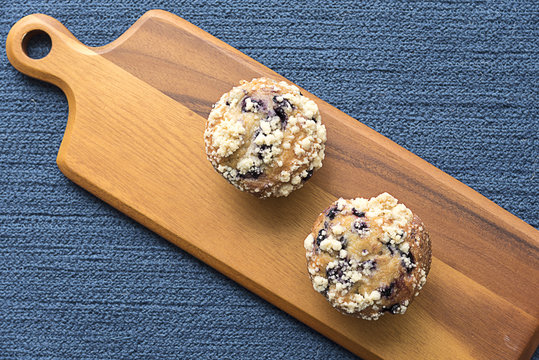 Overhead View Of Blueberry Muffins On Serving Board