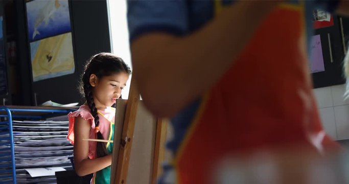 Attentive schoolgirl panting on canvas