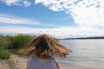 Grumpy girl on beach sea view hair 