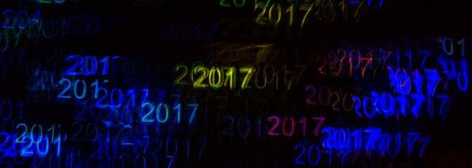 Beautiful background with different colored number 2017, abstract background, year 2017 shapes on black background