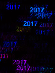 Beautiful background with different colored number 2017, abstract background, year 2017 shapes on black background