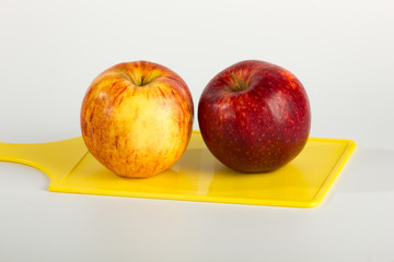 A Pair of Apples on Yellow Cutting Board