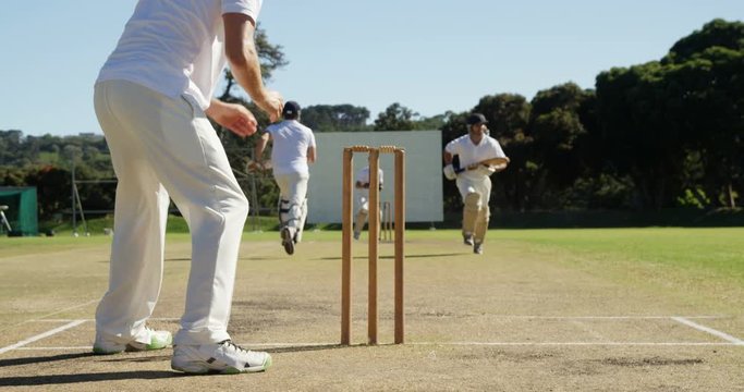 Bowler running out a player during cricket match
