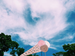 Ice cream cone sign isolated on cloudy sky 