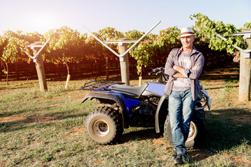 Man standing next to truck in vineyard