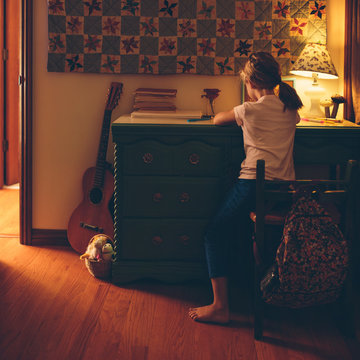 girl doing homework at night