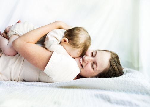 Mother, Embracing A Tired Baby