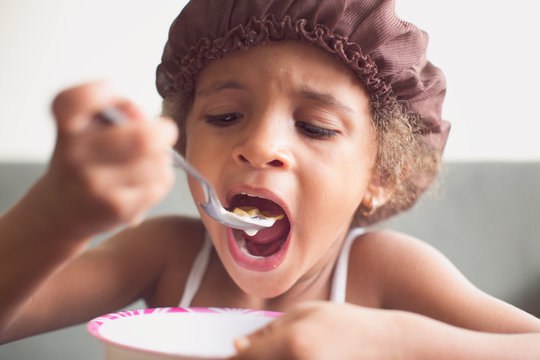 Portrait of a young girl having a bowl of cereal for breakfast
