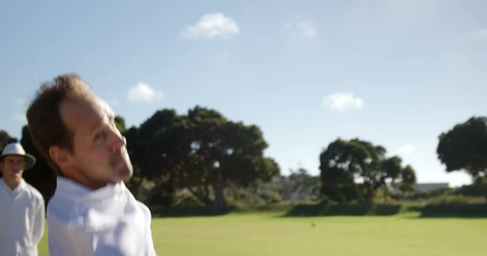 Bowler delivering ball during cricket match