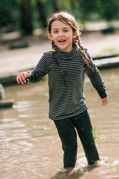 Little Girl in a puddle in the rain