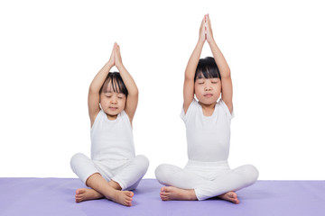 Asian Chinese little girls practicing yoga pose