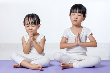 Asian Chinese little girls practicing yoga pose