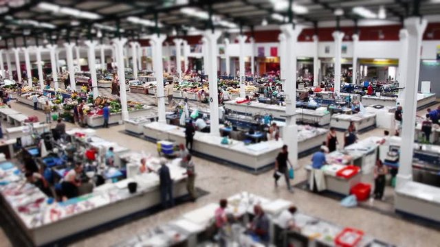 Crowded Farmers Market Time Lapse Tilt Shift. Top view of a huge farmers market with crowd in operation on a busy day