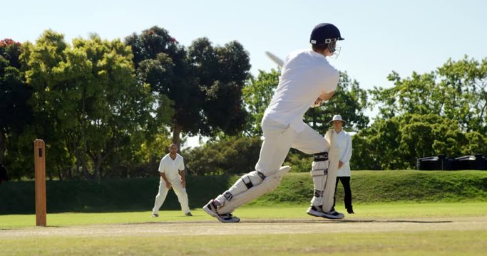Batsman hitting a ball during cricket match