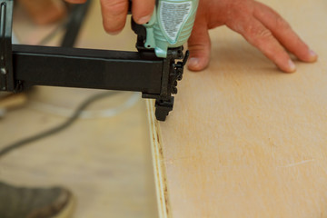 Gauge Finish Nailer man nailed slats custom house building contractor up a wall section for luxury
