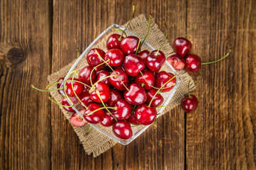 Cherries on wooden background; selective focus