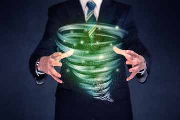 Businessman holding green tornado