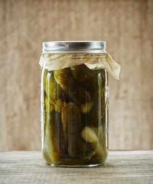 Still life of fermented pickles in glass mason jar