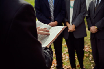 Church: Pastor Reading From Bible At Ceremony