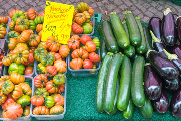 Tomatoes, eggplant and zucchini for sale at a market