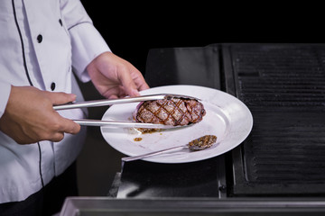 Chef cooking beef steak