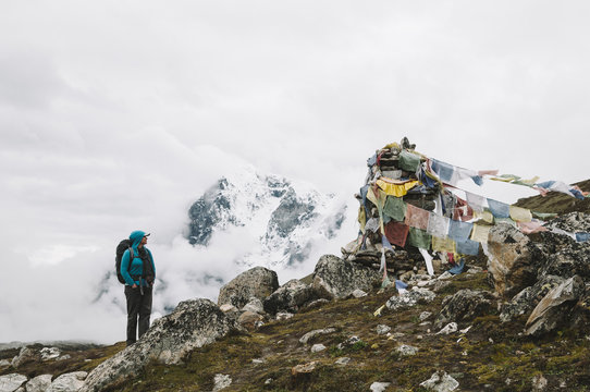 Female trekker looking at a memorial while walking to Gorak Shep, Everest Region, Nepal.