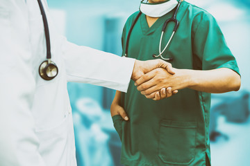 Doctors shaking hands. Medical people teamwork.
