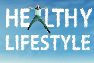 Man jumps with Healthy Lifestyle text