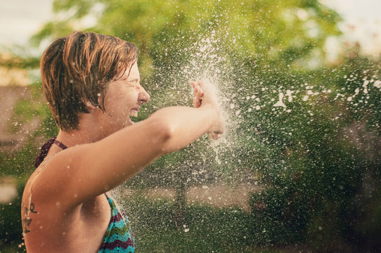 Woman Getting Sprayed By Water