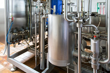 Industrial dairy production. View on the steel pipelines on the milk factory.