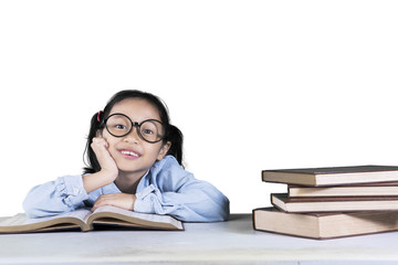 Pensive girl student with books on studio