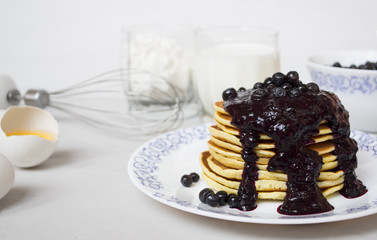 Stack of pancakes with blended berries on white background