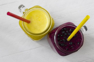 Homemade yellow and purple cocktails. Healthy breakfast or snack.