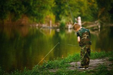Boy catches fish in the river.The concept of tourism and leisure