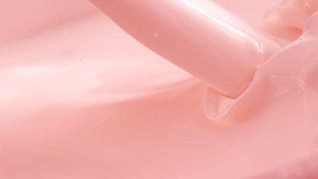 Pouring Strawberry Flavored Milk. Slow Motion.
