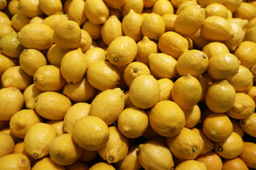 Yellow lemons on the market counter - fruit background