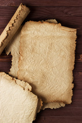 Ancient scroll or papyrus on wooden background