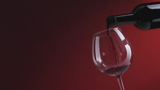 Red wine pouring into a glass
