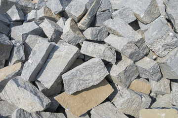 Pile of gray color stones for building the house. Background with pile of rectangular shaped stones