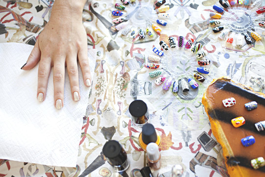 view from above of lady's hand receiving a manicure / nail art