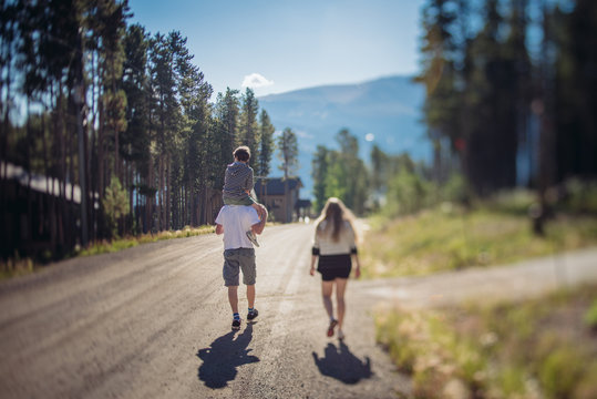 Family walking on a mountain road in summer