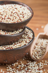 Organic mixed red and white Quinoa  in ceramic bowls on an old rustic table. Healthy grains, superfood.  Selective focus