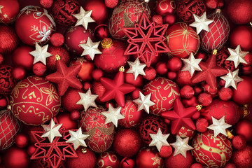 Christmas red and gold bauble and star decorations forming a background.