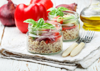 Warm quinoa salad with vegetables - avocado, red onion, tomatoes, bell pepper, Basil and olive oil. Healthy grain, super-duper. Selective focus