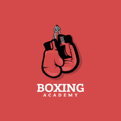 Boxing logo concept on red background with hanging boxing gloves. 