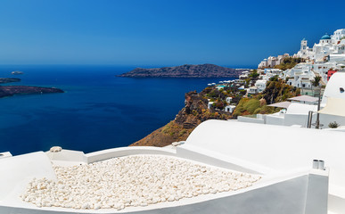 White stone texture on the roof with views of the Caldera and the sea from Fira town in Santorini - Greece